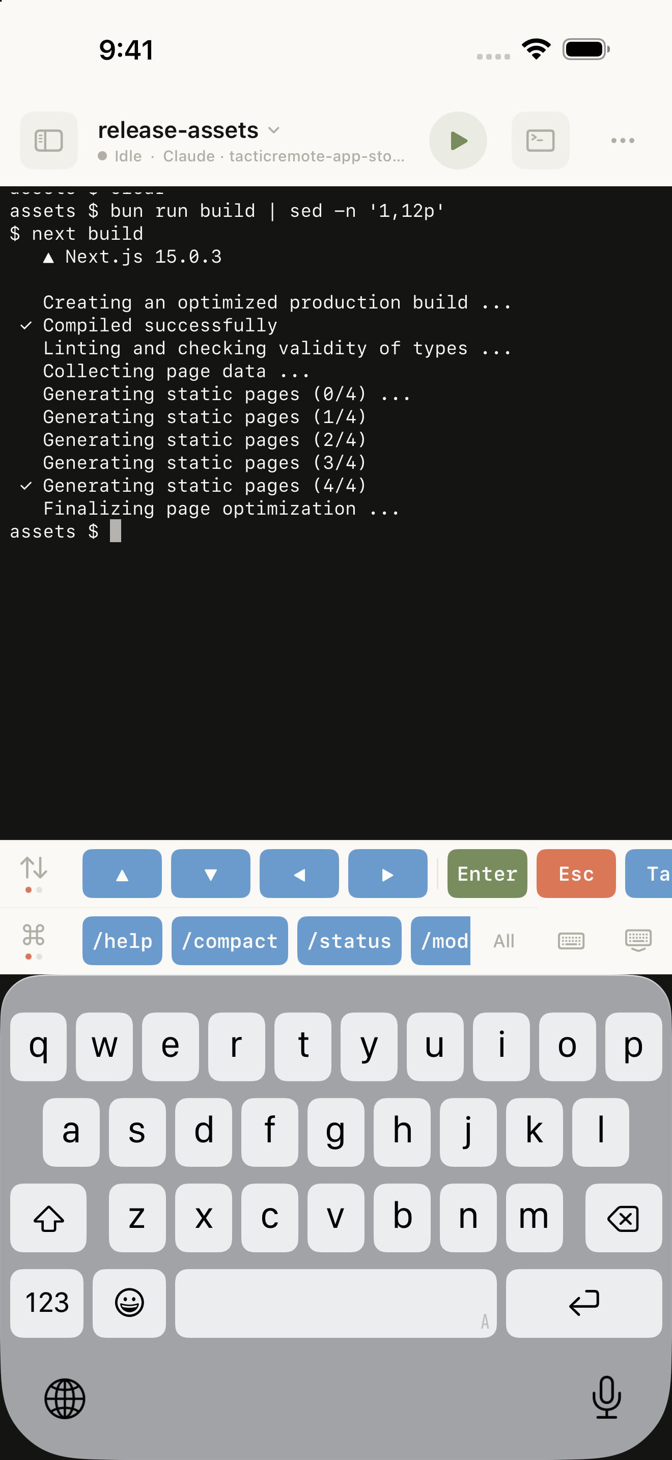 The native iPhone terminal with build output, shortcut keys, and the English keyboard